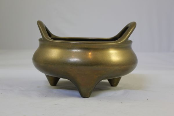 A large Chinese bronze ding shaped censer, Xuande six character mark, probably 18th century, 19.5cm., diam.13.3cm.